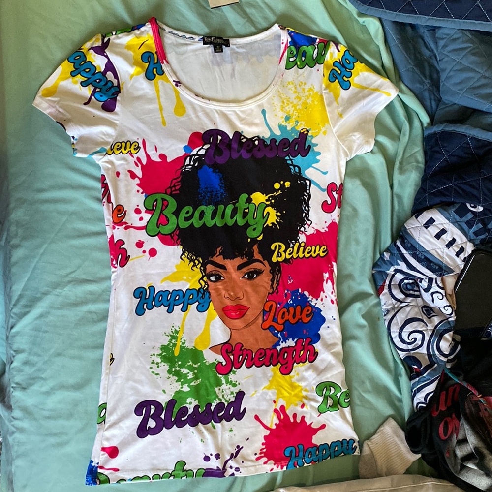 This shirt is a Medium size. There are variety of colors and words in bold.